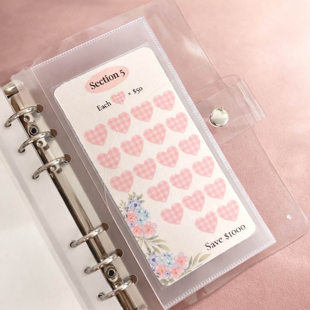 Clear plastic case with pink heart stickers and a floral design on a pink surface