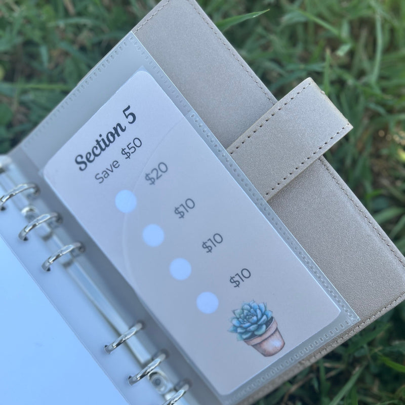 Planner with a money tracking card on grass