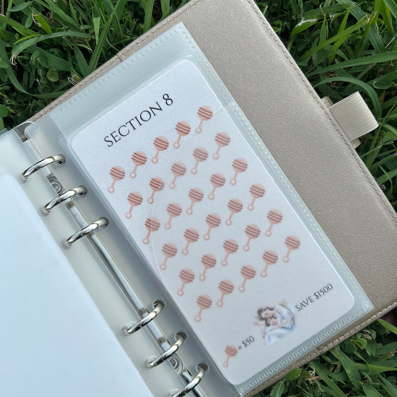 Open planner with a section divider on a grass background