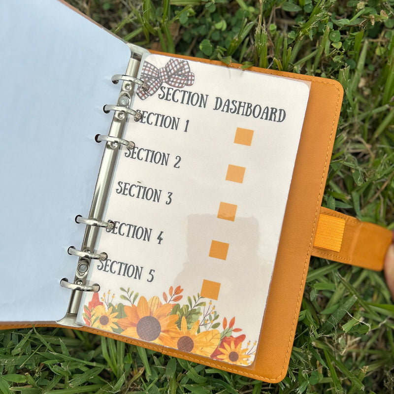 Open planner with dashboard section on grass