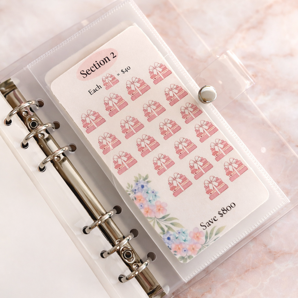 Planner with decorative stickers on a pink background