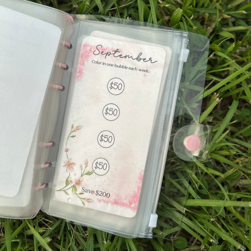 Planner with money tracking stickers on grass