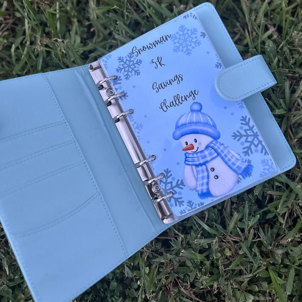 Light blue planner with snowman design on grass