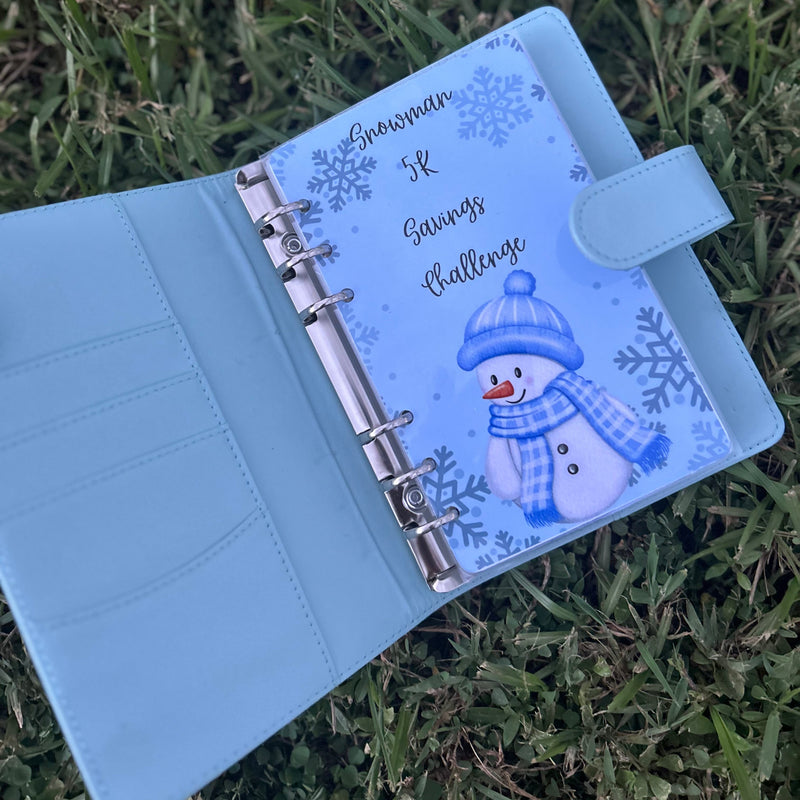 Light blue planner with snowman design on grass