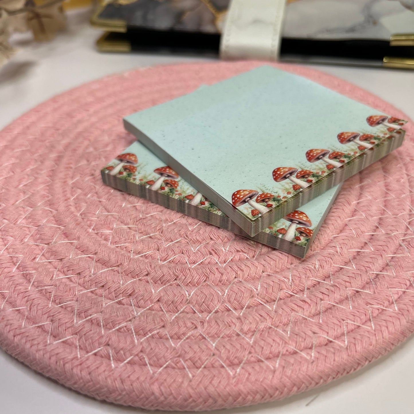 Pink woven mat with a decorative card on top