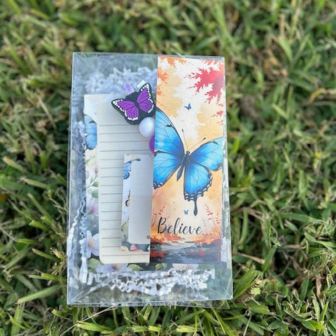 Decorative card with butterfly design on grass