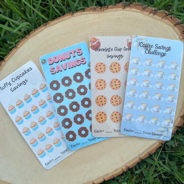Four stickersheets with different designs on a wooden surface with grass background