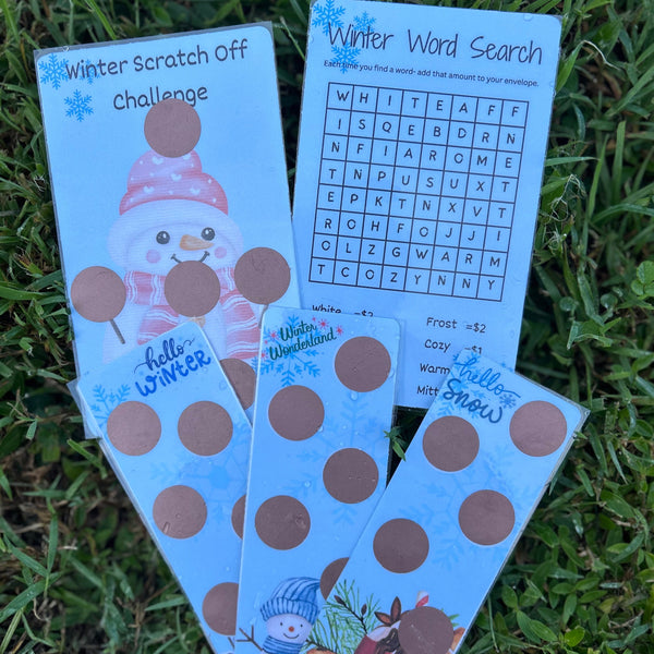 Three winter-themed activity cards on grass